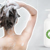 Woman washing hair with sulfate-free shampoo; benefits of using a gentle, natural hair cleanser.